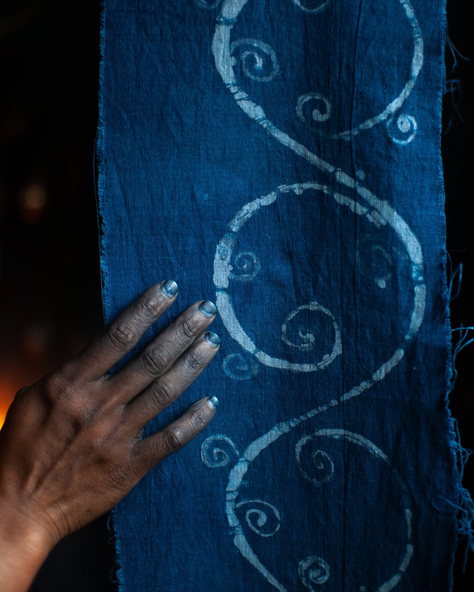 indigo-dyed batik fabric detail with dyers blue hand